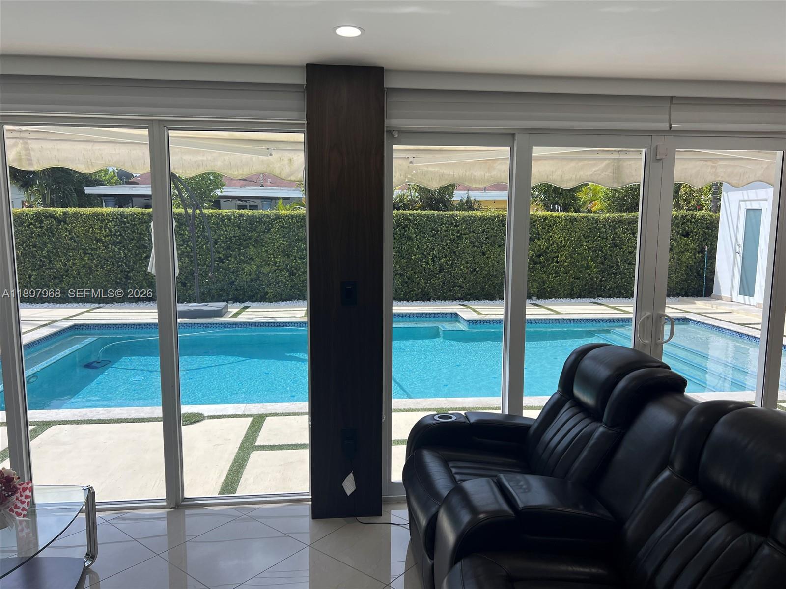 3530 Southwest 126th Avenue Miami, FL 33175 - Photo 48 of 52 a living room with furniture and a floor to ceiling window