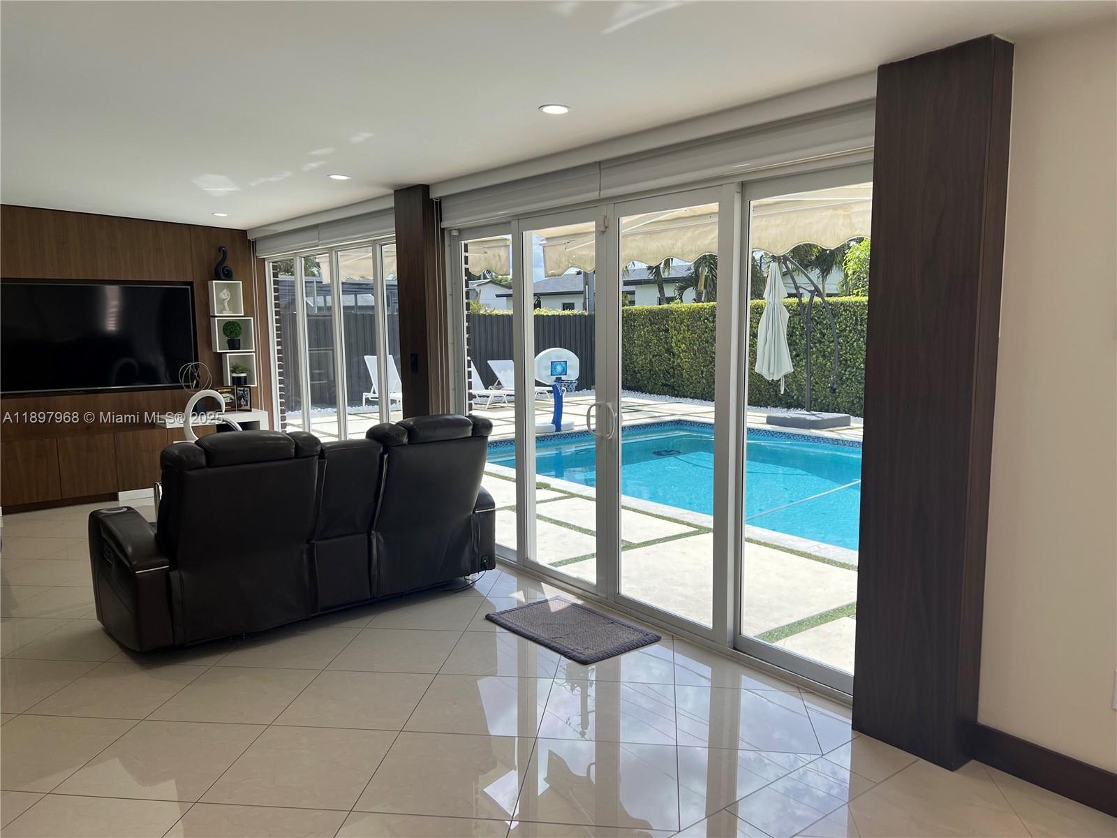 3530 Southwest 126th Avenue Miami, FL 33175 - Photo 53 of 58 a living room with furniture and a flat screen tv