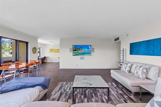 a living room with couches and a flat screen tv