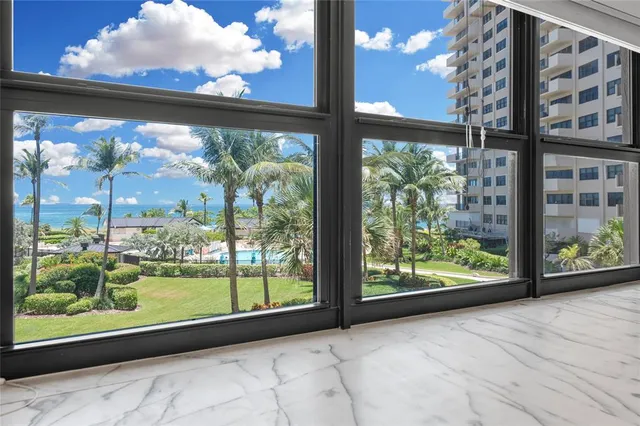 a bathroom with a granite countertop bathtub sink vanity mirror and toilet
