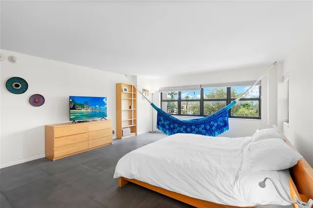 a bathroom with a granite countertop sink a toilet and a mirror