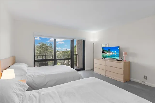 a lobby with furniture and a flat screen tv