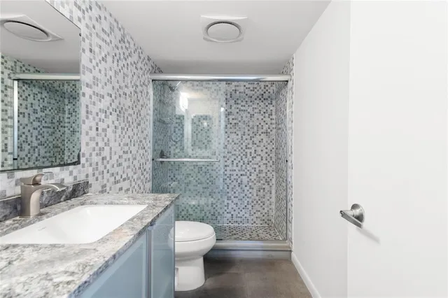 a room with pool table and wooden floor