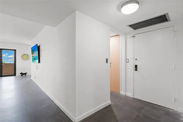 a dining room with furniture a rug and a floor to ceiling window