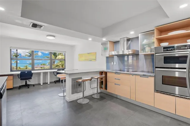 a kitchen with stainless steel appliances granite countertop a stove and a sink