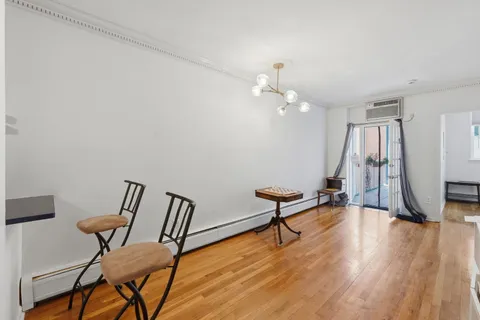 a view of a room with furniture and wooden floor