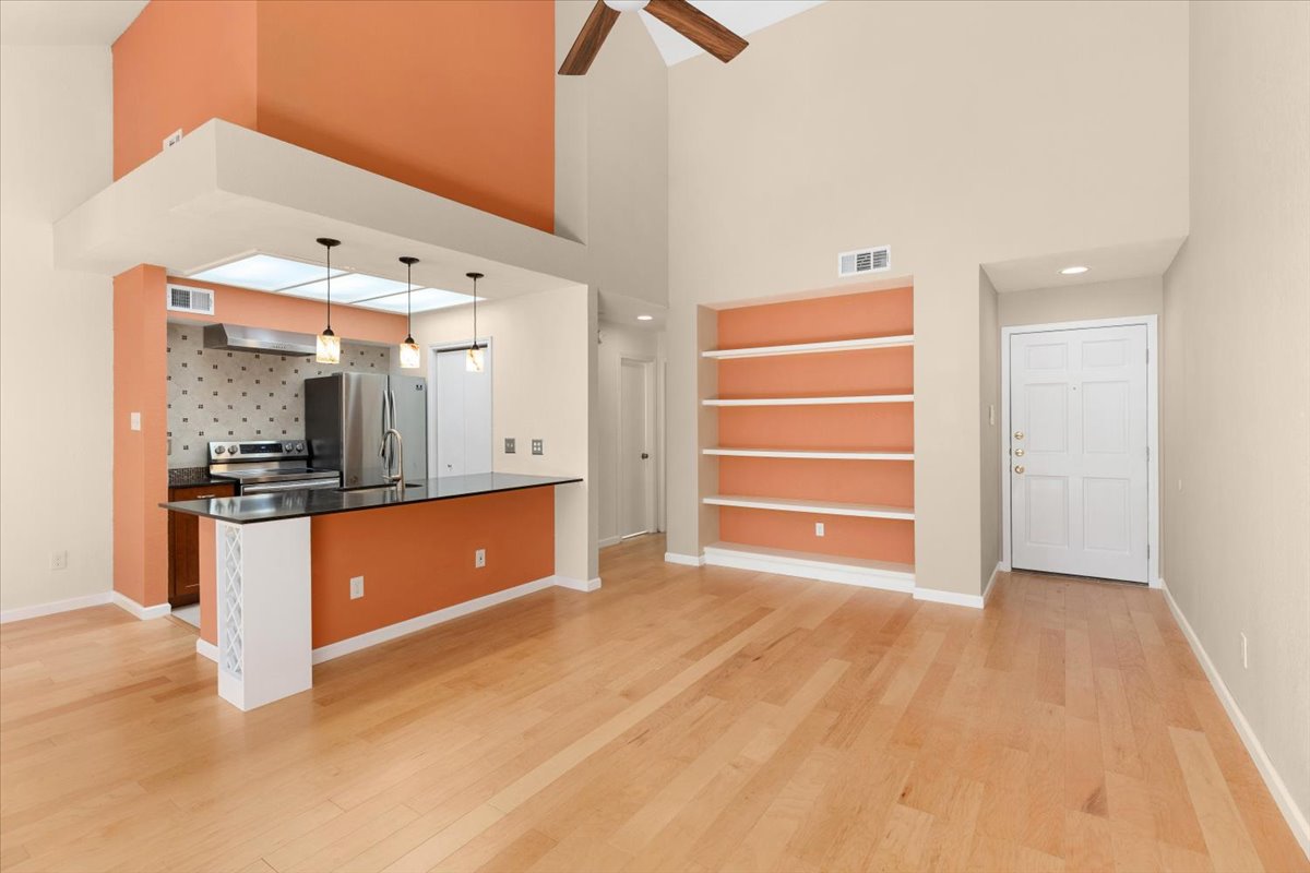 4711 Spicewood Springs Road, Unit 4222 Austin, TX 78759 - Photo 12 of 35 An open-concept living area with soaring, vaulted ceilings and light hardwood floors creates an airy atmosphere.