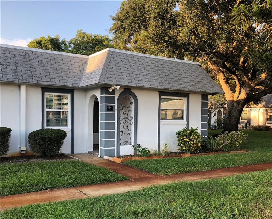 4241 Sheldon Place, Unit 4241 New Port Richey, FL 34652 - Photo 1 of 1 a front view of a house with garden