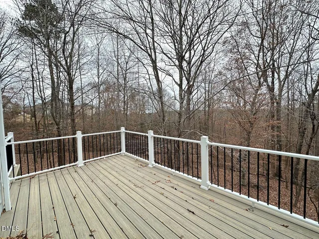 a view of balcony with wooden floor and fence