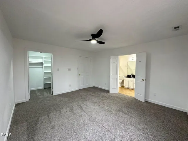 a view of empty room with ceiling fan