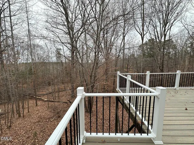a view of balcony with wooden floor and fence