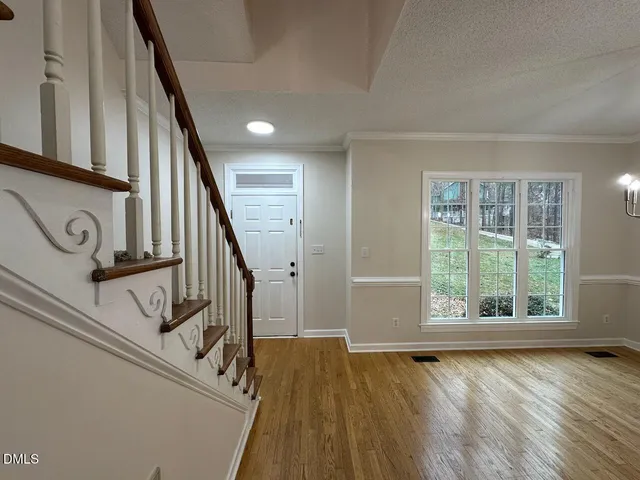 a view of an entryway with wooden floor and door