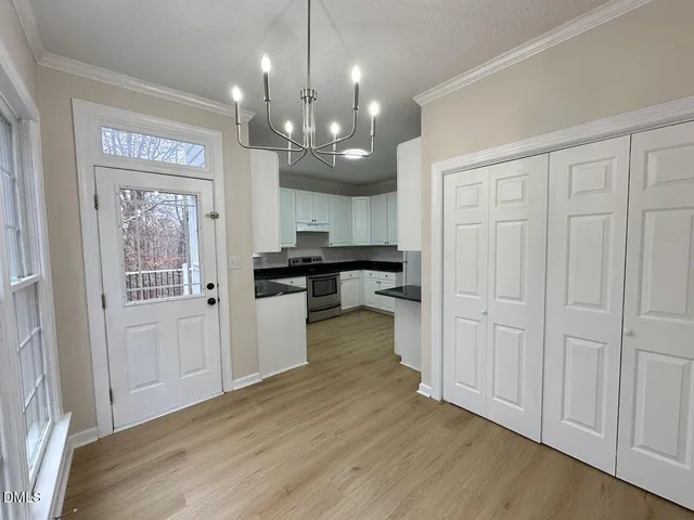 a view of a kitchen with a sink stainless steel appliances and cabinets