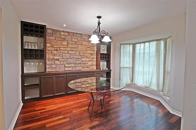 a room with wooden floor and lots of windows