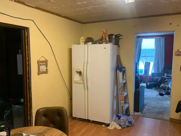 a view of hallway with furniture and wooden floor