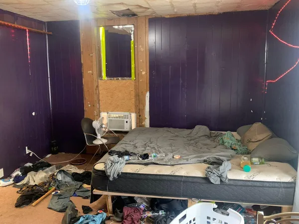 a bedroom with a bed and a wooden cabinets