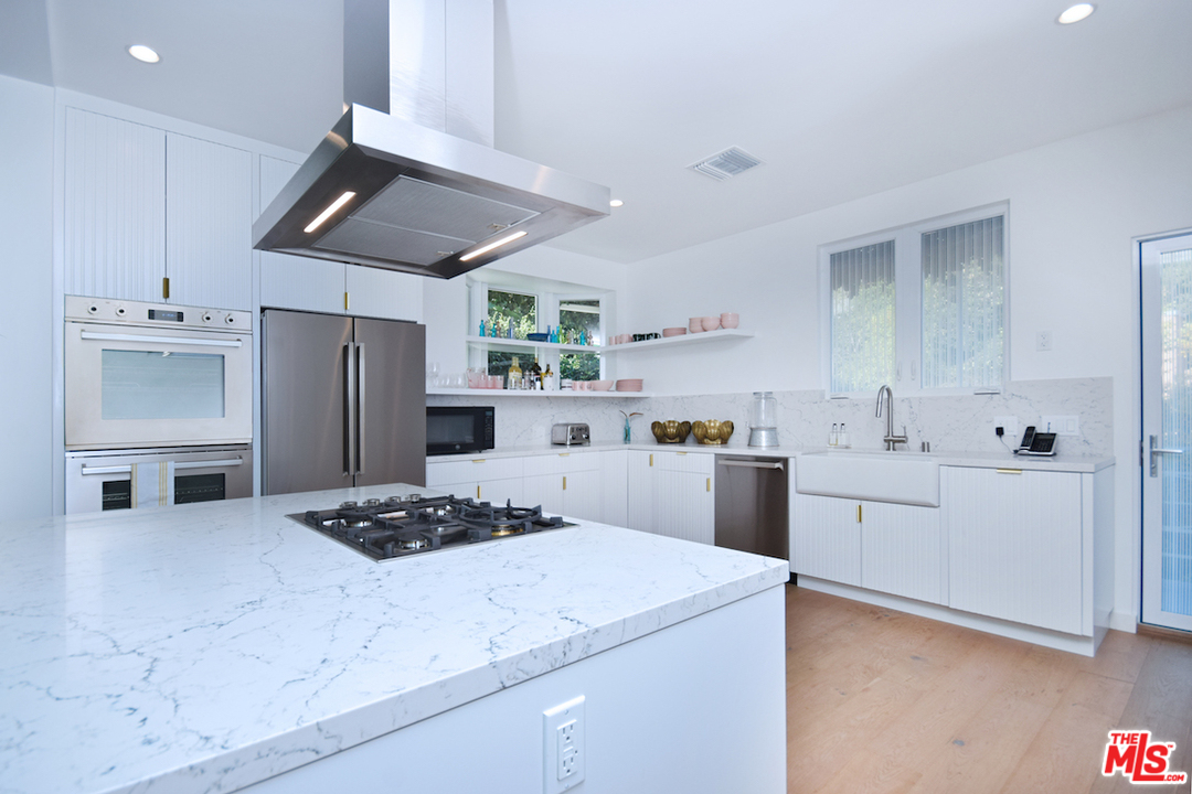 3848 Fredonia Drive Los Angeles, CA 90068 - Photo 6 of 23 a kitchen with stainless steel appliances kitchen island a sink stove and refrigerator