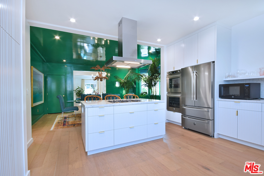 3848 Fredonia Drive Los Angeles, CA 90068 - Photo 7 of 23 a kitchen with stainless steel appliances kitchen island granite countertop a refrigerator and a stove top oven
