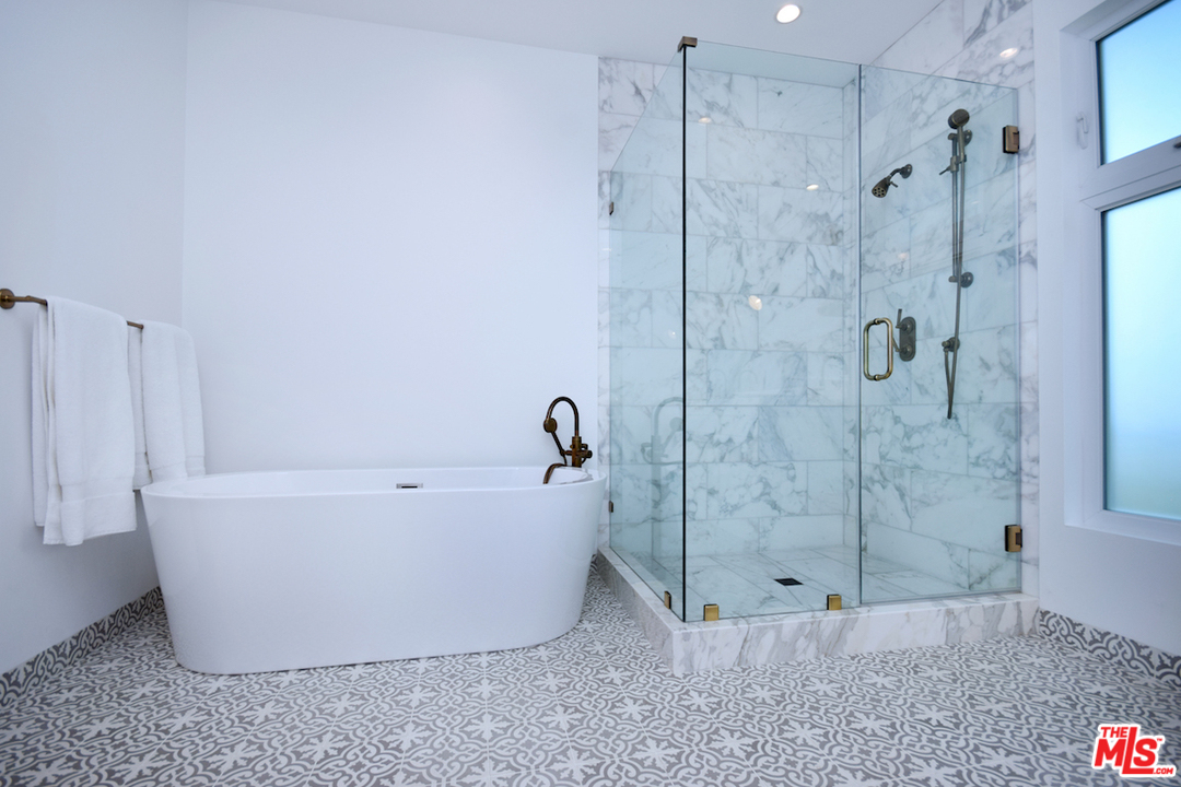 3848 Fredonia Drive Los Angeles, CA 90068 - Photo 10 of 23 a white bath tub sitting next to a shower