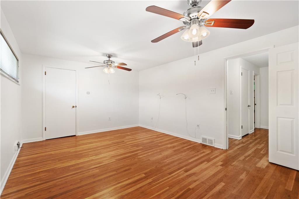 127 Church Road Pittsburgh, PA 15209 - Photo 17 of 35 wooden floor in an empty room with a fan