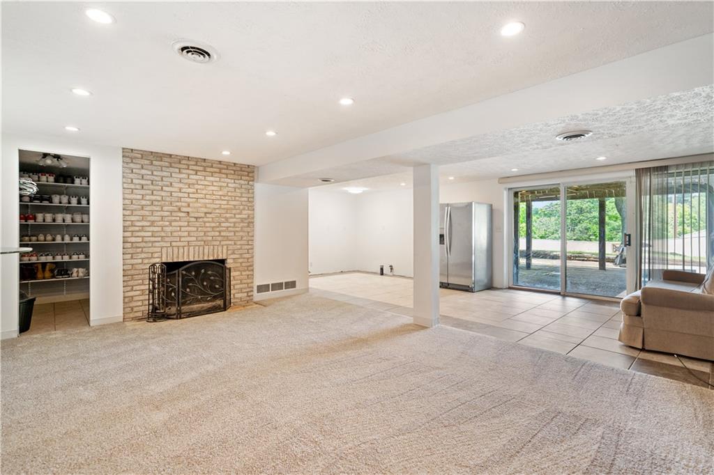 127 Church Road Pittsburgh, PA 15209 - Photo 23 of 35 a view of an empty room with a fireplace and a window