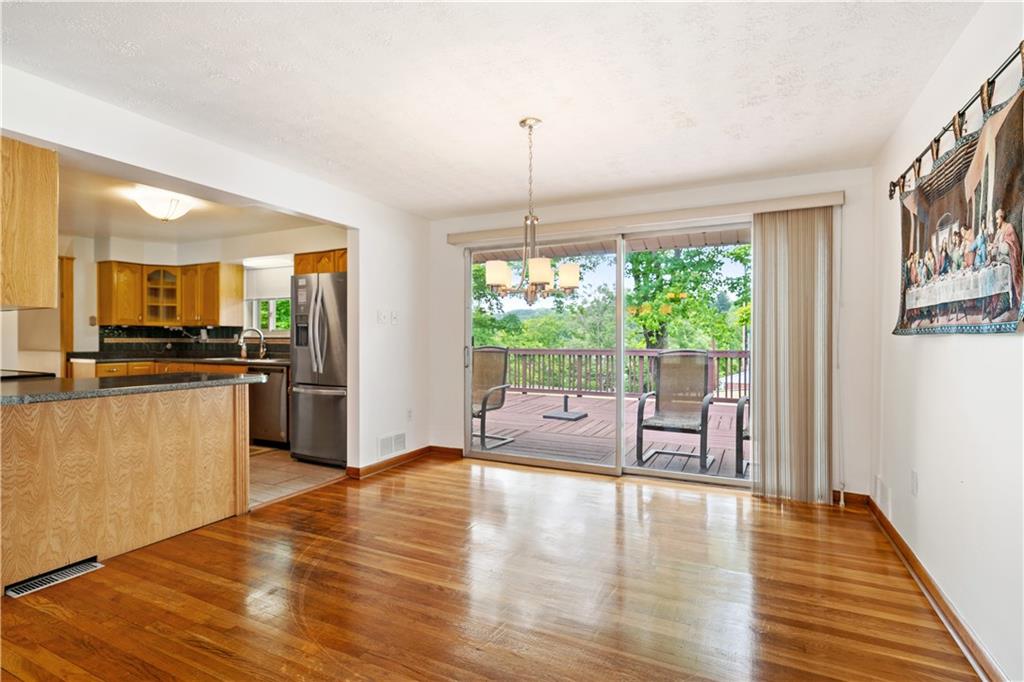 127 Church Road Pittsburgh, PA 15209 - Photo 6 of 35 a kitchen with stainless steel appliances wooden floor and refrigerator