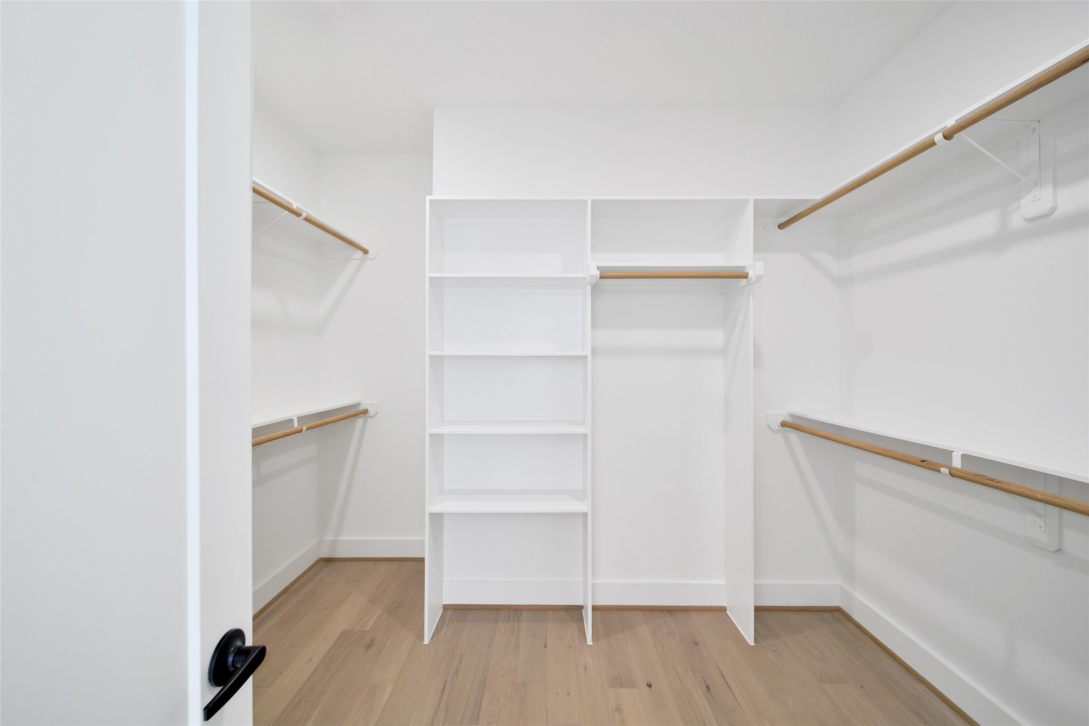 717 Marcella Street, Unit F Houston, TX 77091 - Photo 13 of 37 a view of walk in closet with empty racks