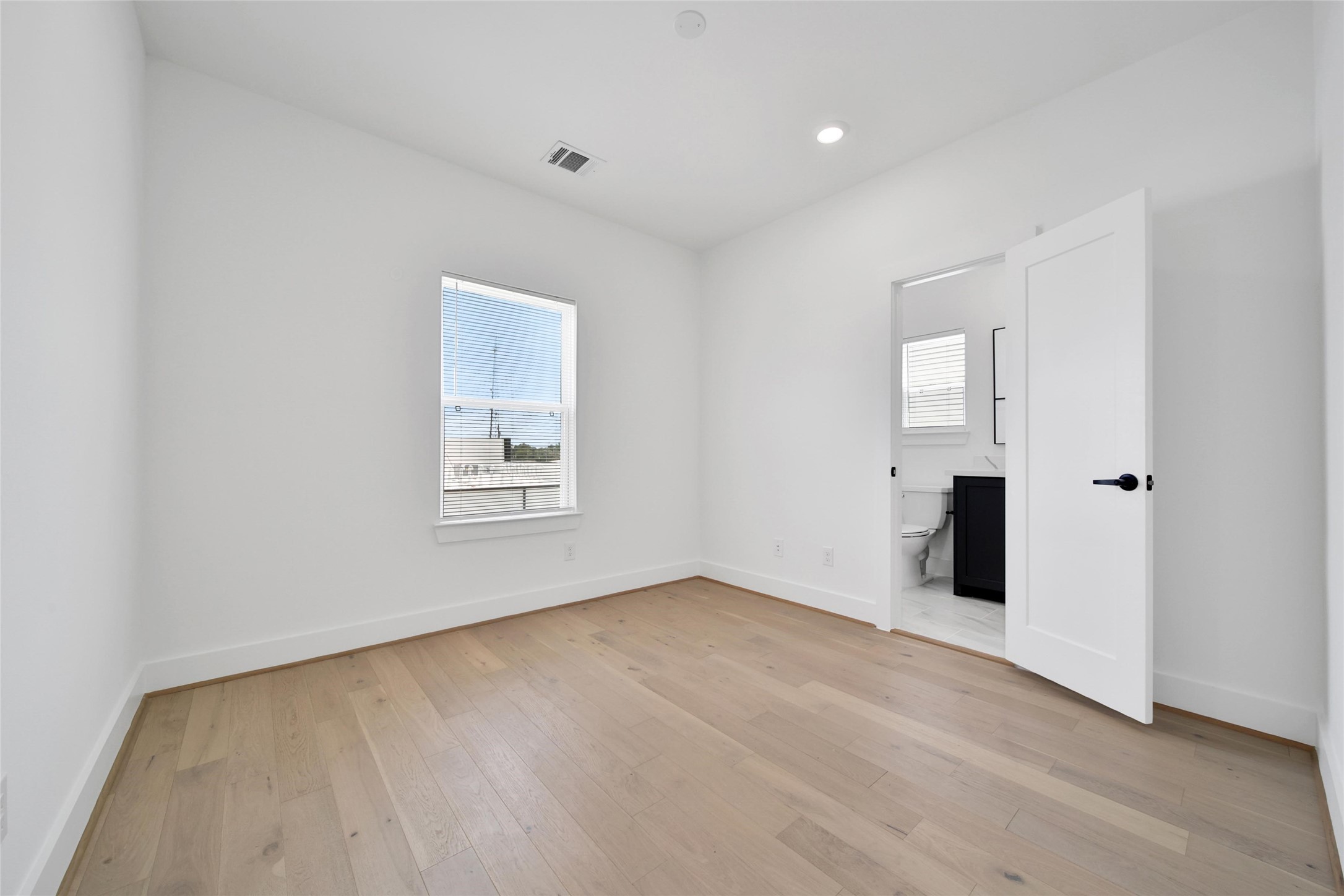 717 Marcella Street, Unit F Houston, TX 77091 - Photo 15 of 37 an empty room with windows and closet