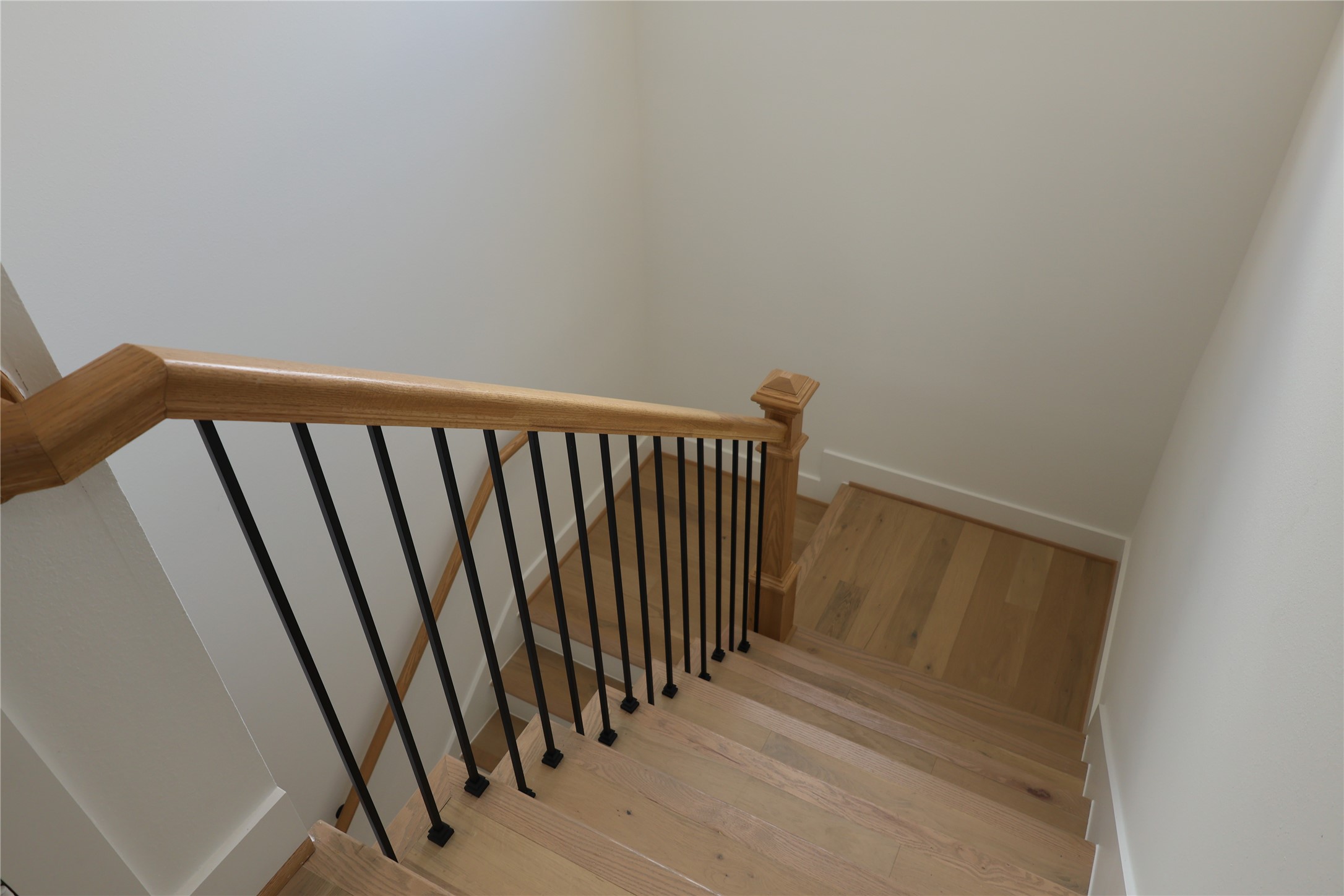 717 Marcella Street, Unit F Houston, TX 77091 - Photo 17 of 37 a view of a hallway with wooden floor and stairs