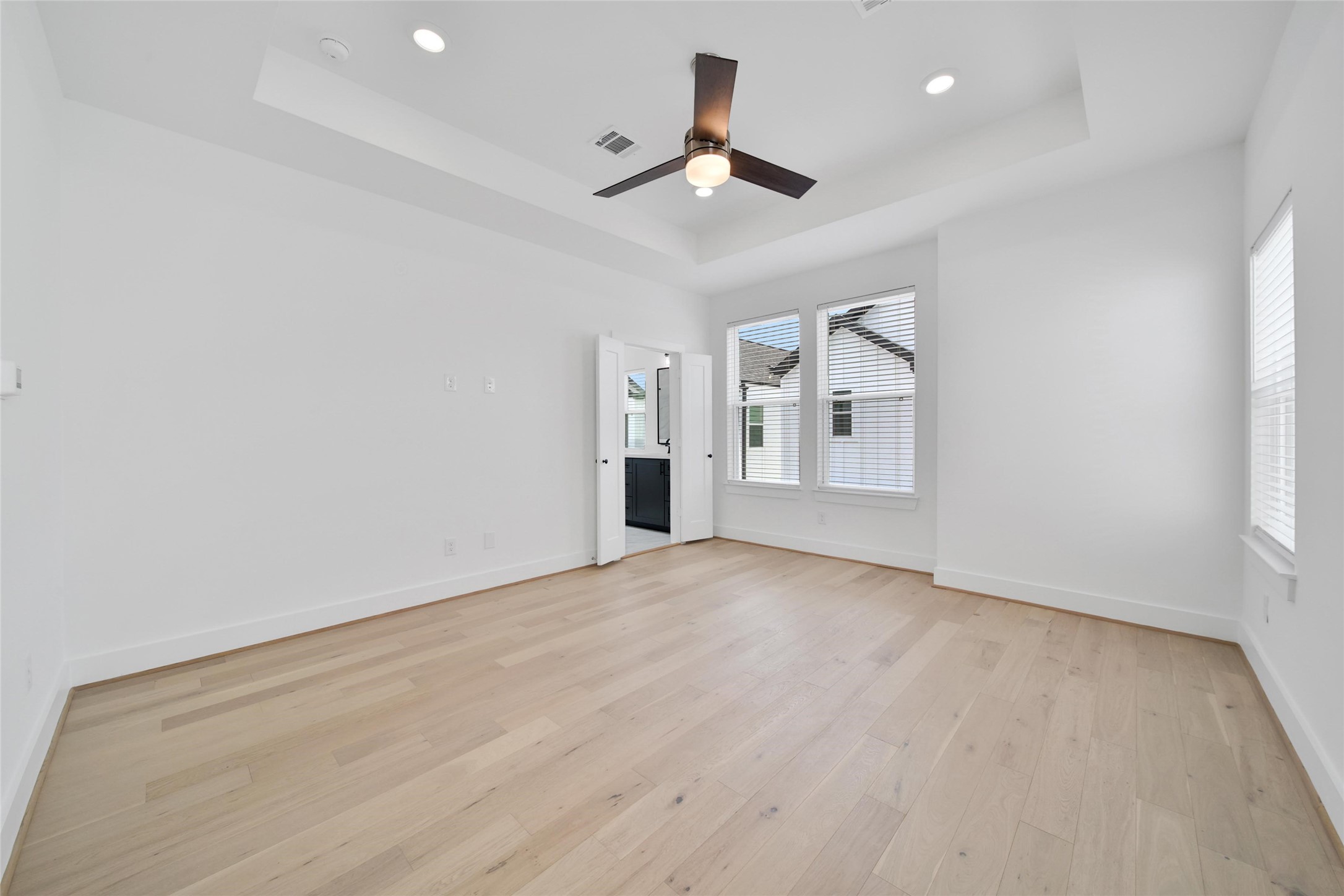 717 Marcella Street, Unit F Houston, TX 77091 - Photo 4 of 37 wooden floor in an empty room with a window