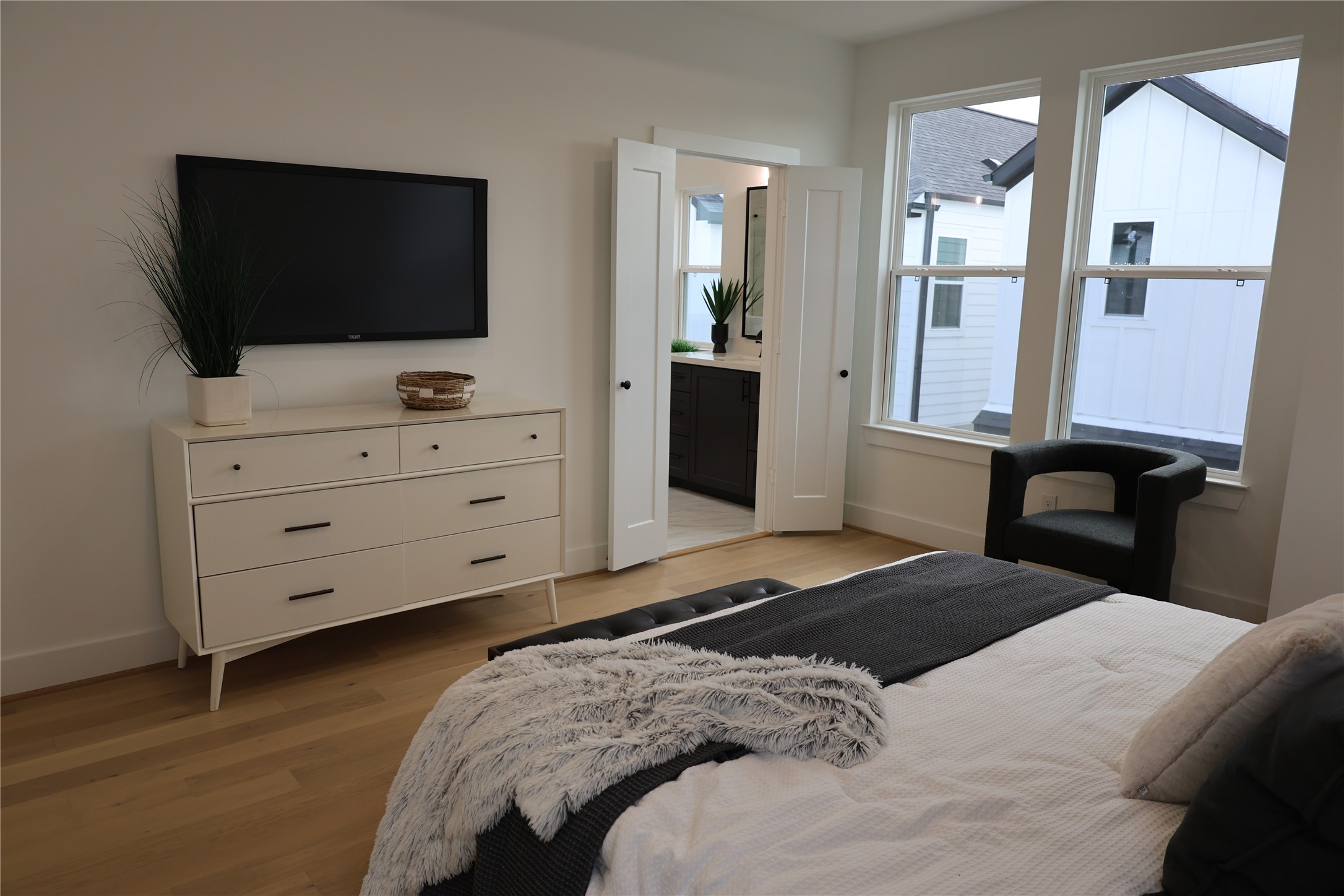 717 Marcella Street, Unit F Houston, TX 77091 - Photo 5 of 37 a bedroom with a bed and a flat screen tv