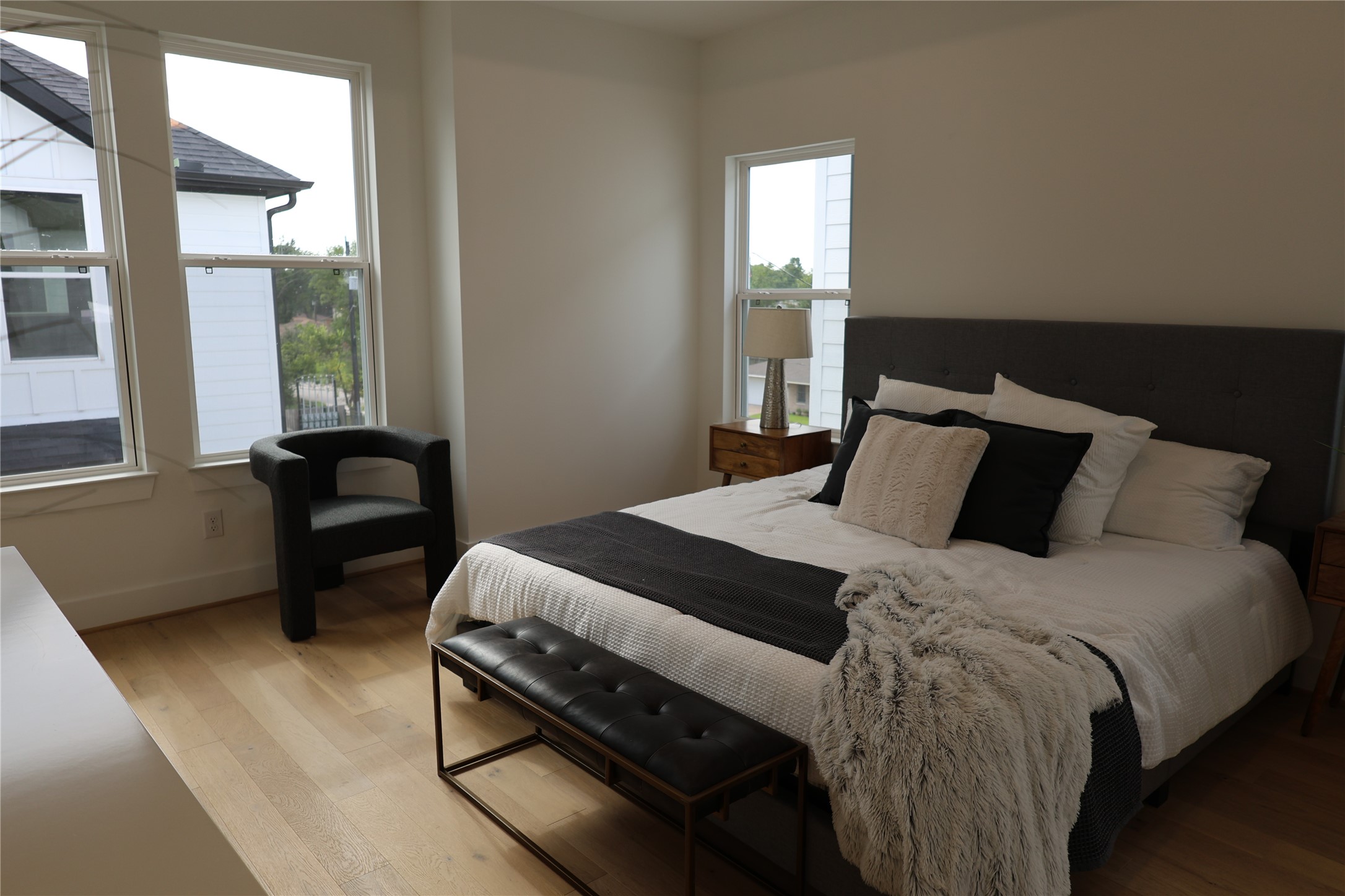 717 Marcella Street, Unit F Houston, TX 77091 - Photo 6 of 37 a bedroom with a bed and wooden floor