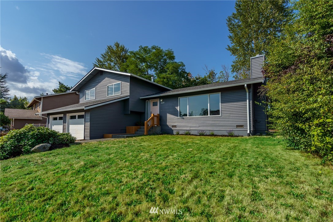 1620 Index Avenue Southeast Renton, WA 98058 - Photo 2 of 39 a front view of house with yard and trees in the background