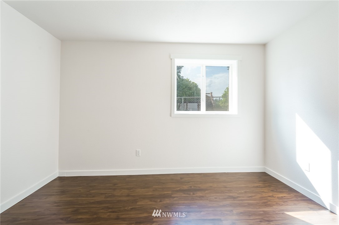 1620 Index Avenue Southeast Renton, WA 98058 - Photo 18 of 39 a view of an empty room with wooden floor and a window