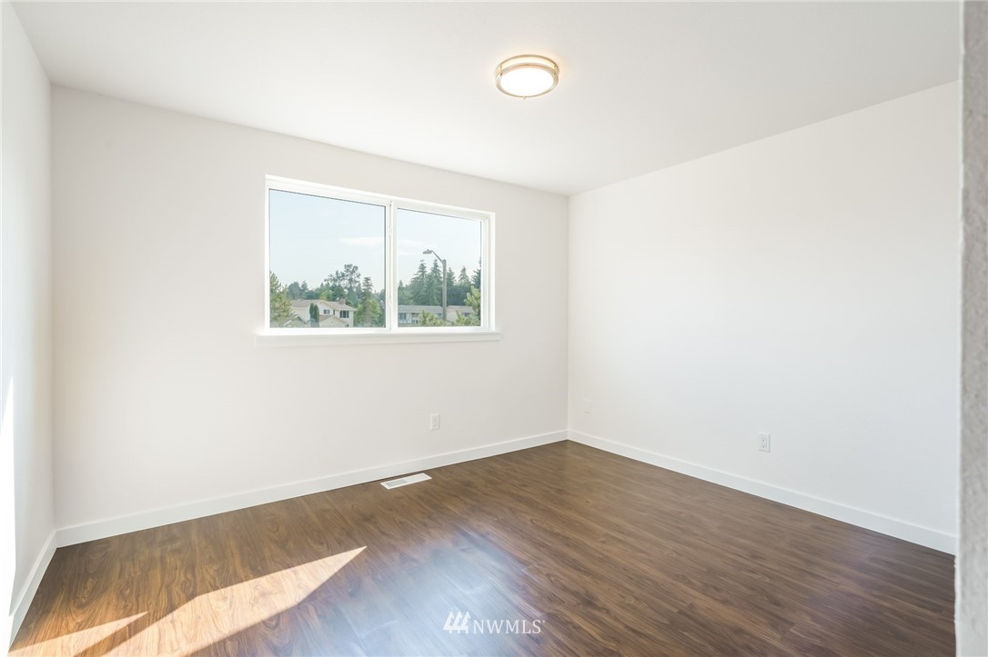 1620 Index Avenue Southeast Renton, WA 98058 - Photo 24 of 39 an empty room with wooden floor and windows