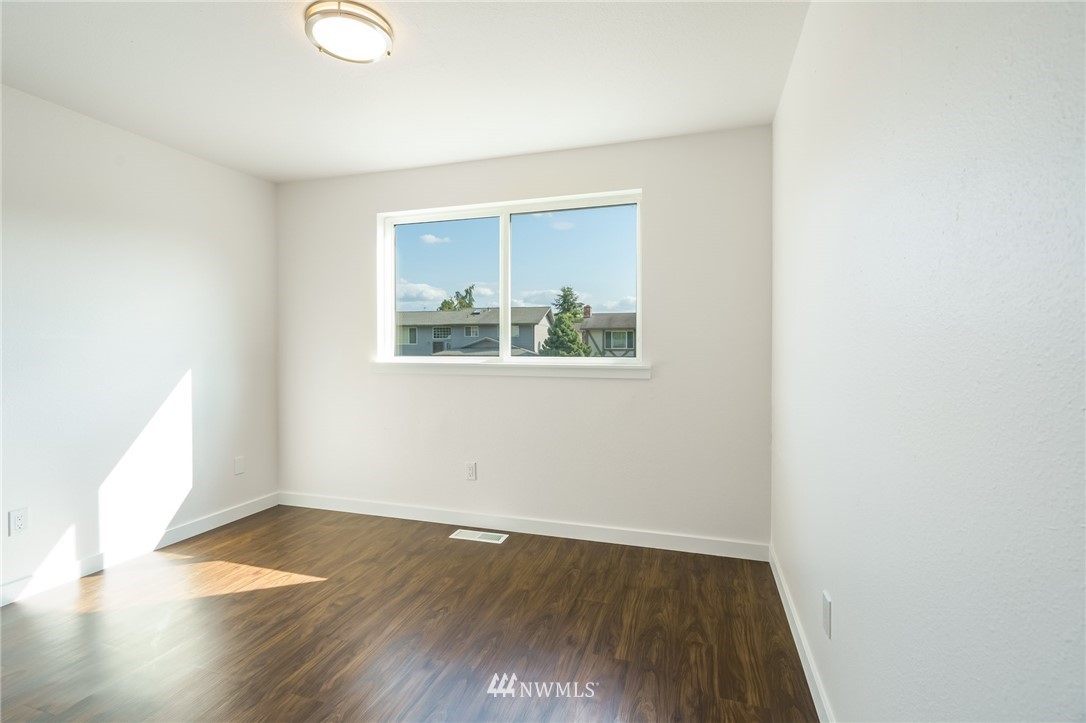 1620 Index Avenue Southeast Renton, WA 98058 - Photo 26 of 39 an empty room with wooden floor and windows