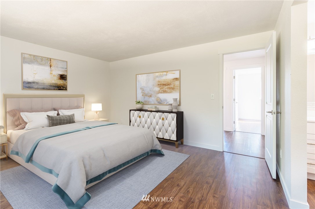 1620 Index Avenue Southeast Renton, WA 98058 - Photo 29 of 39 a bedroom with a large bed and paintings on the wall