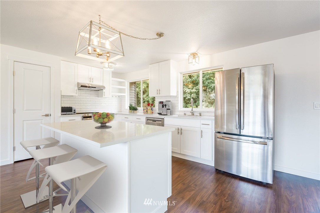 1620 Index Avenue Southeast Renton, WA 98058 - Photo 5 of 39 a kitchen with kitchen island white cabinets and stainless steel appliances