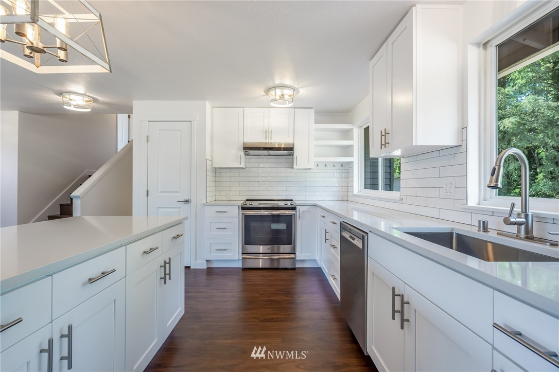 1620 Index Avenue Southeast Renton, WA 98058 - Photo 6 of 39 a kitchen with stainless steel appliances granite countertop a stove and a sink