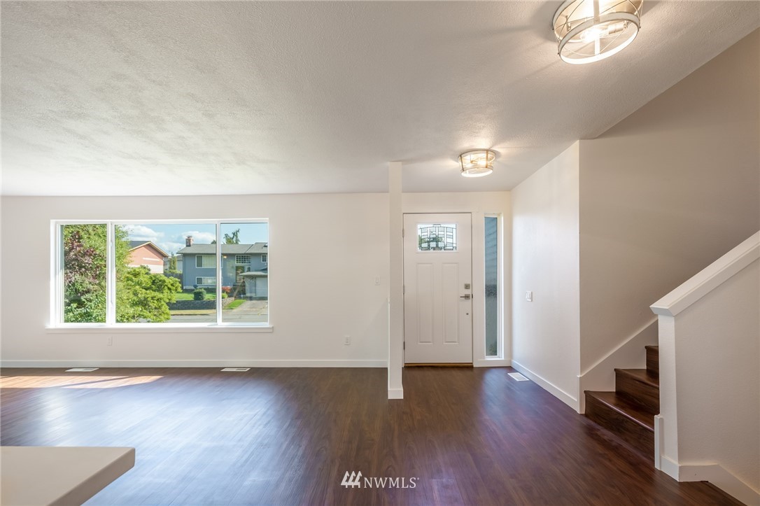 1620 Index Avenue Southeast Renton, WA 98058 - Photo 9 of 39 an empty room with wooden floor and windows