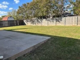 a view of a swimming pool with a yard