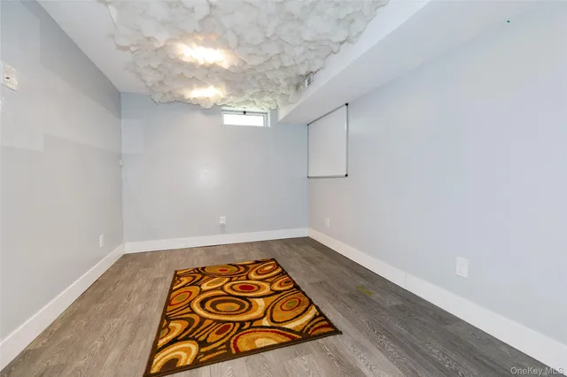 a view of storage and utility room with wooden floor