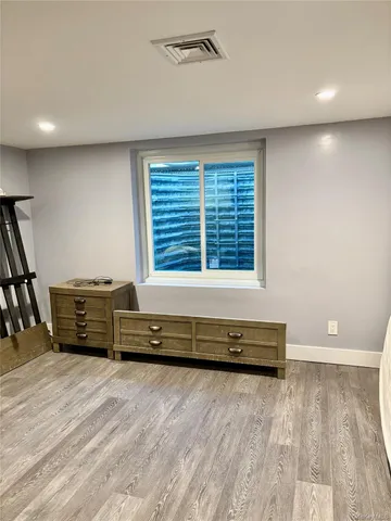 a view of a room with furniture wooden floor and window