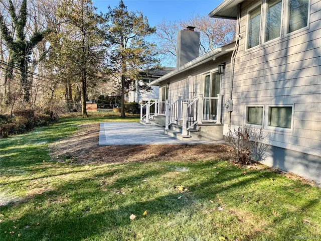 a backyard of a house with table and chairs