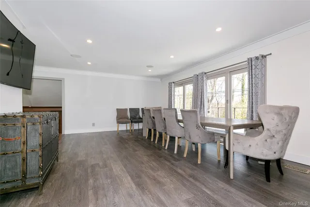 a view of a dining room with furniture window and wooden floor