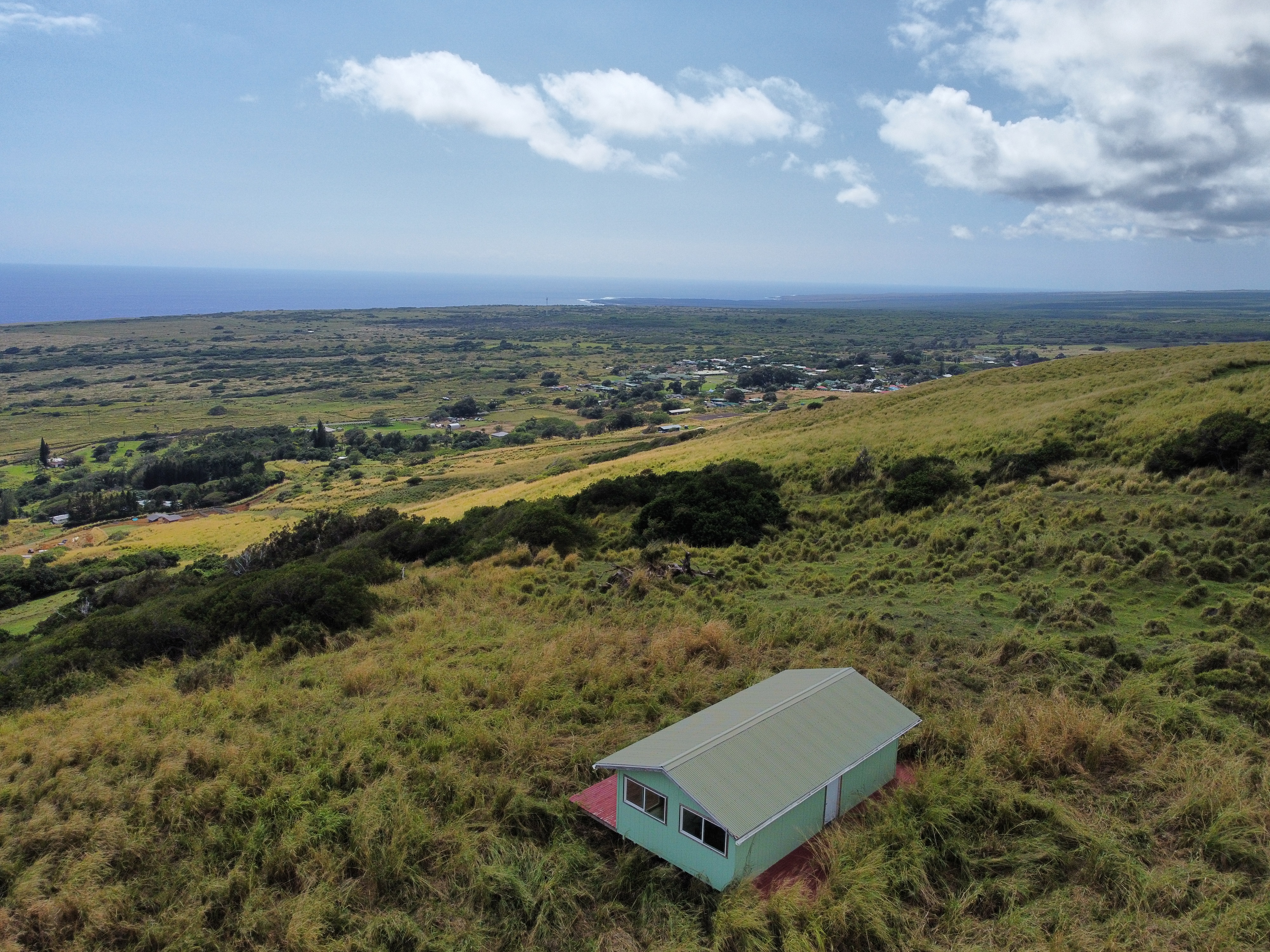 an aerial view of a house with a yard