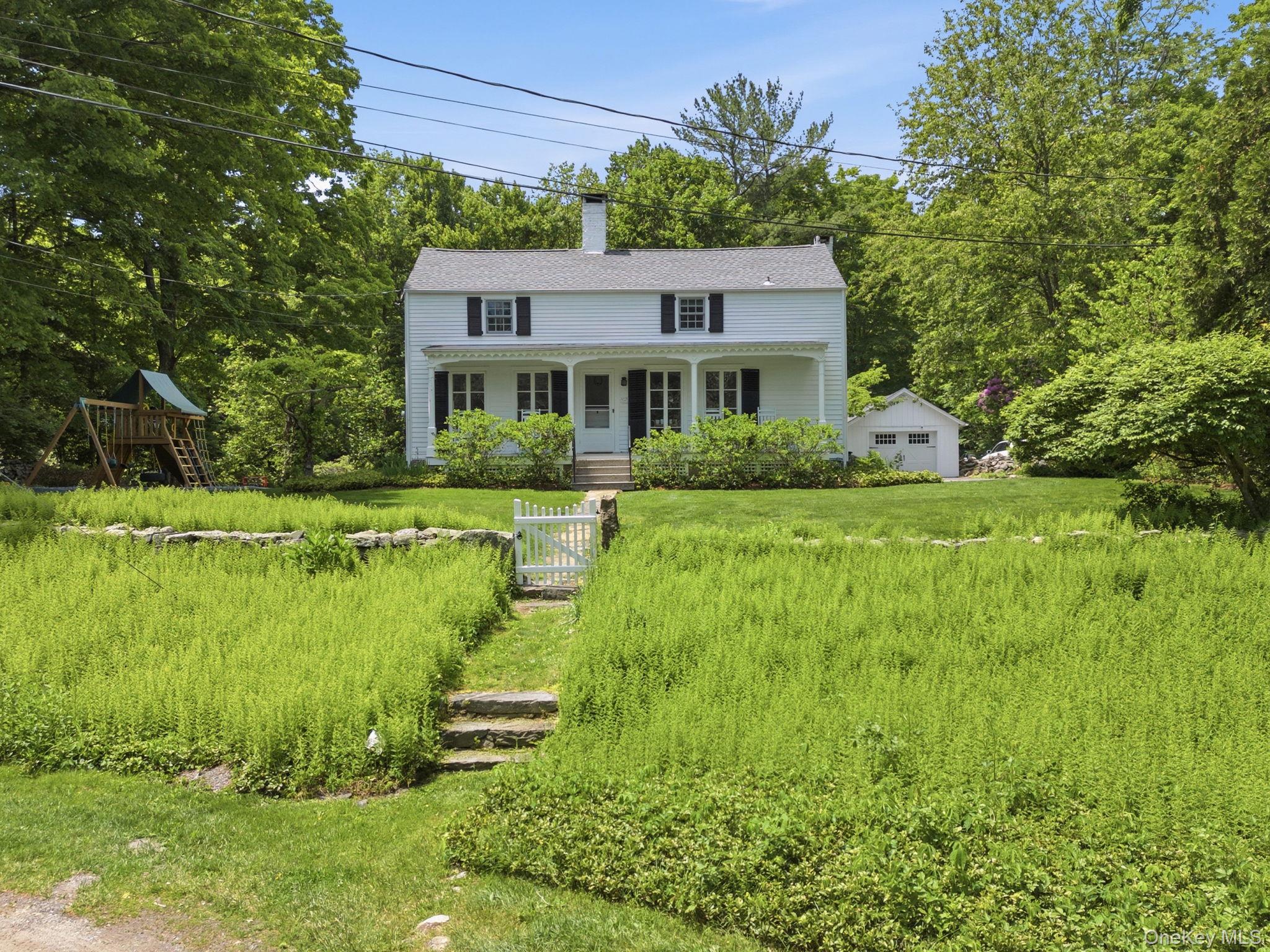 23 Pound Ridge Road Pound Ridge, NY 10576 - Photo 1 of 40 a front view of a house with a yard