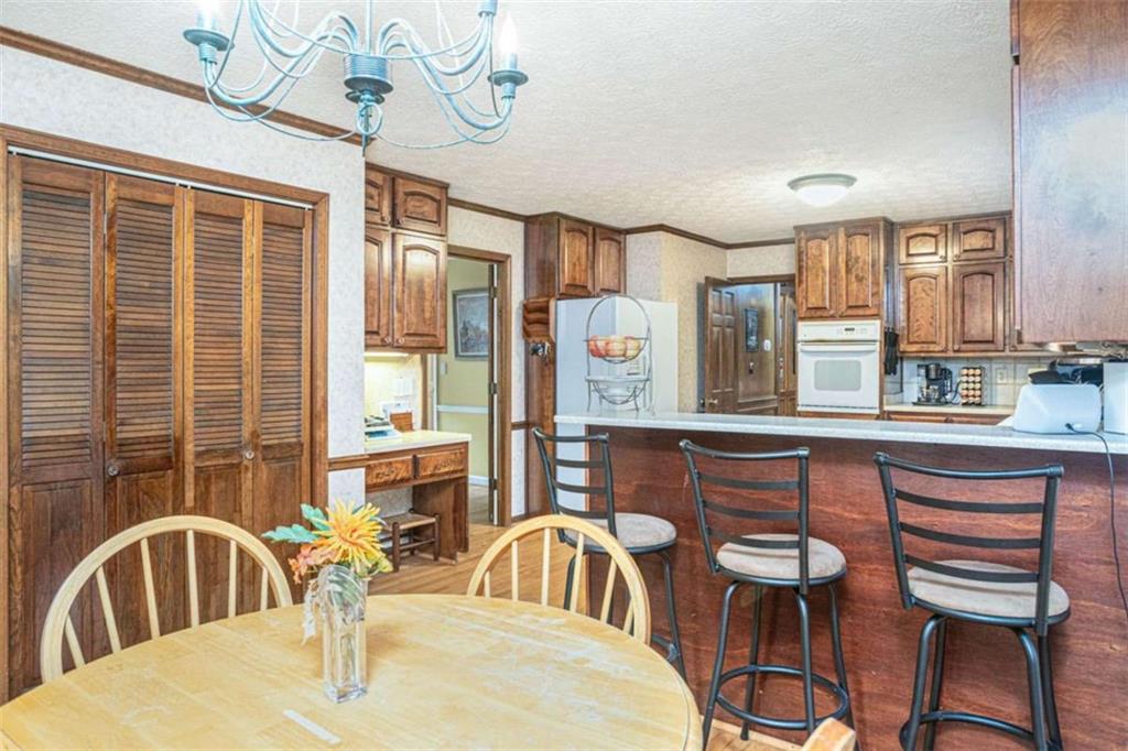 3838 Hunting Ridge Drive Southwest Lilburn, GA 30047 - Photo 21 of 56 a kitchen with a table chairs and a chandelier