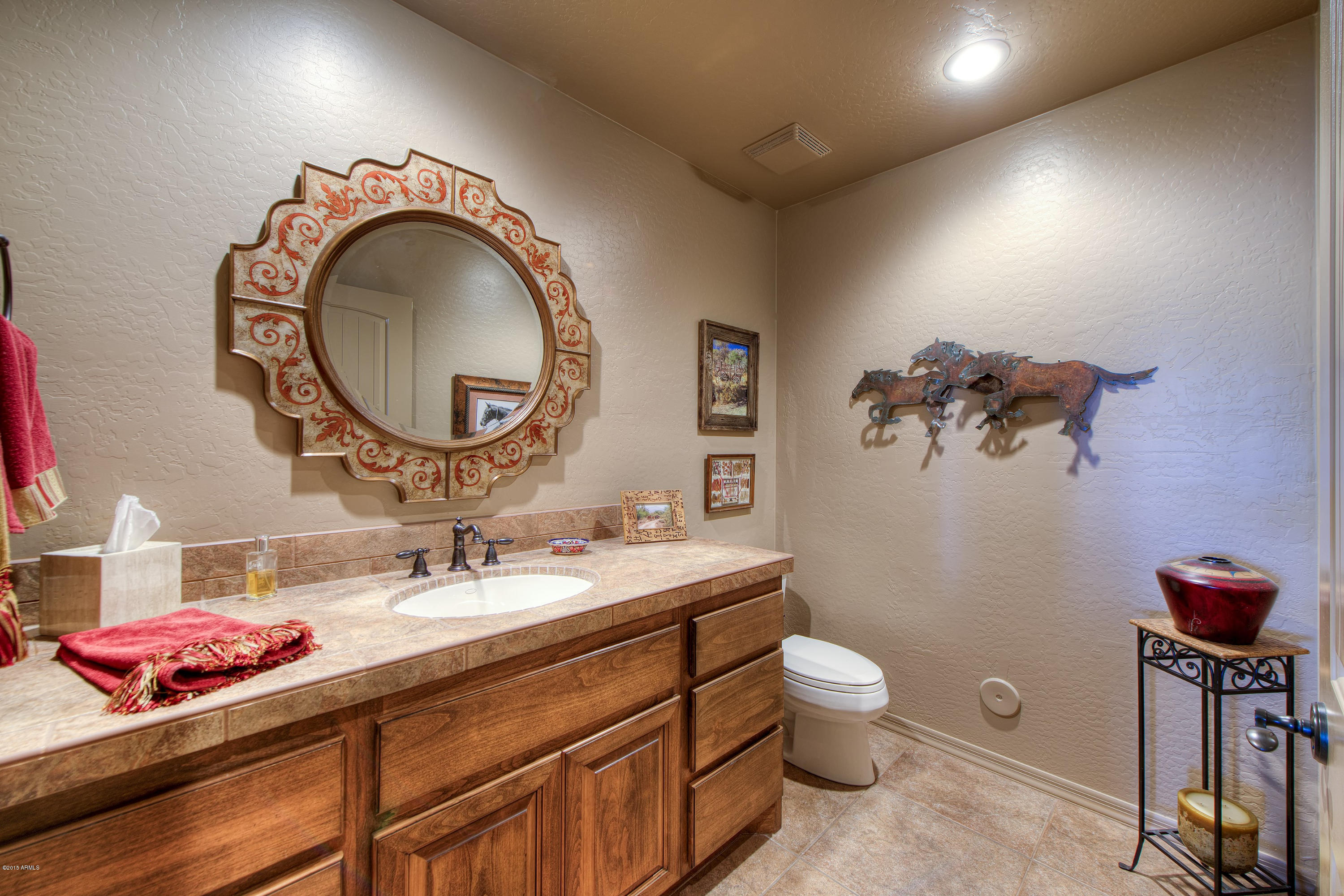 27822 North Quail Spring Road Rio Verde, AZ 85263 - Photo 16 of 33 a bathroom with a toilet a sink and a mirror
