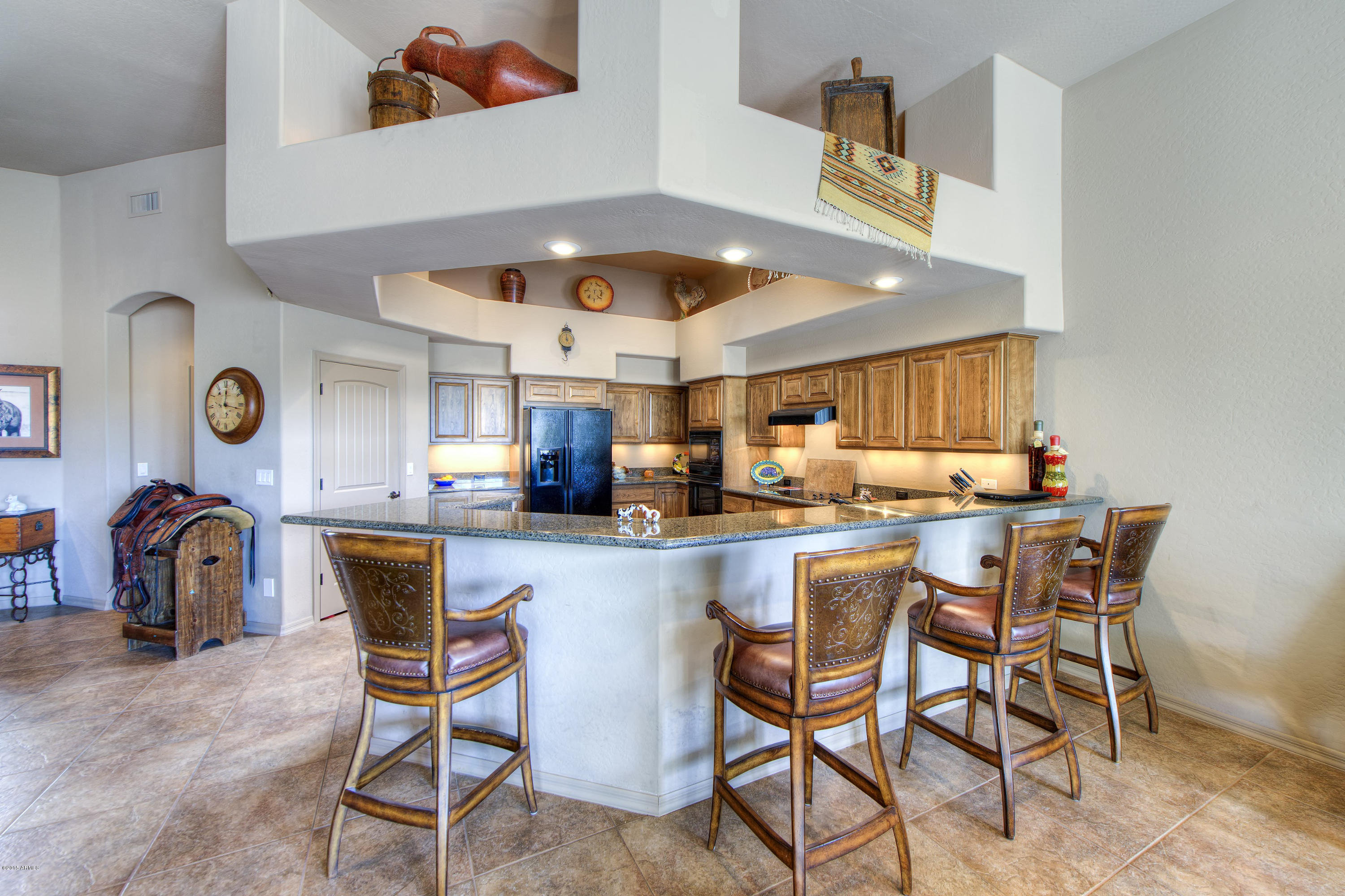 27822 North Quail Spring Road Rio Verde, AZ 85263 - Photo 6 of 33 a kitchen with a dining table chairs and white cabinets